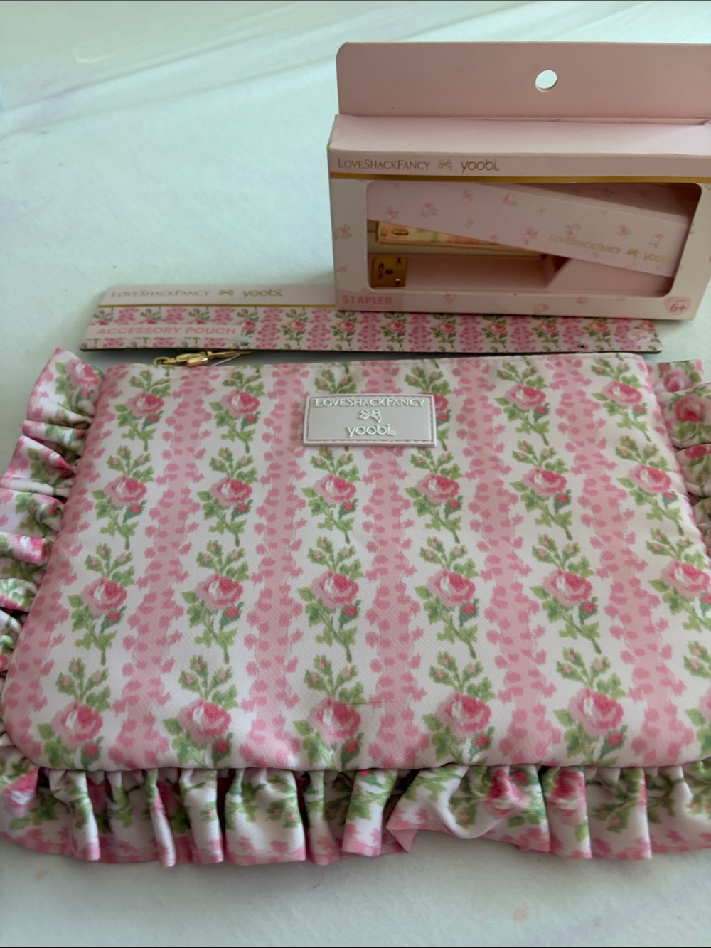 LoveShackFancy Pink Rose-Print Ruffled Cosmetic Pouch and stapler